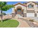 Inviting two-story residence with three-car garage, attractive landscaping, and a welcoming entrance at 6638 Dazzling Heights Ln, Las Vegas, NV 89110