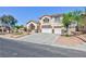 Charming two-story house featuring a well-maintained lawn and a spacious three-car garage at 6638 Dazzling Heights Ln, Las Vegas, NV 89110