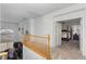 Hallway with wood railing leads to bedroom with elegant four-poster bed at 6638 Dazzling Heights Ln, Las Vegas, NV 89110