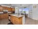 Eat-in kitchen features an island, granite counters, stainless appliances, and breakfast nook with bay window at 6638 Dazzling Heights Ln, Las Vegas, NV 89110
