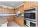 Gourmet kitchen featuring stainless steel appliances, granite countertops, and ample cabinet space at 6638 Dazzling Heights Ln, Las Vegas, NV 89110
