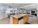 Eat-in kitchen with granite counters, center island and sink, and views of the backyard and living room at 6638 Dazzling Heights Ln, Las Vegas, NV 89110