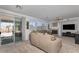 Cozy living room with a fireplace, large windows, and sliding door access to the outdoor patio at 6638 Dazzling Heights Ln, Las Vegas, NV 89110
