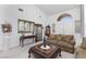 Inviting living room featuring plush seating, a decorative mirror, and a stylish coffee table at 6638 Dazzling Heights Ln, Las Vegas, NV 89110