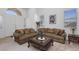 Comfortable living room featuring plush seating, a stylish coffee table, and lots of natural light at 6638 Dazzling Heights Ln, Las Vegas, NV 89110