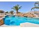 Inviting backyard pool with rock waterfall feature and lush tropical landscaping at 6638 Dazzling Heights Ln, Las Vegas, NV 89110