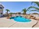 Beautiful backyard pool area with desert landscaping and palm trees at 6638 Dazzling Heights Ln, Las Vegas, NV 89110