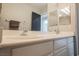 Modern bathroom featuring double sinks, a spacious vanity, and a well-lit mirror for a functional design at 664 Mystic Cliffs Ave, Las Vegas, NV 89183