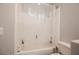 Bathroom featuring a shower-tub combo with a white tile surround, offering a clean and functional design at 664 Mystic Cliffs Ave, Las Vegas, NV 89183