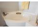 Bright bathroom featuring a soaking tub with yellow towels and a decorative candle for a spa-like experience at 664 Mystic Cliffs Ave, Las Vegas, NV 89183