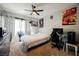 Cozy bedroom with a ceiling fan, featuring playful posters and a dedicated workspace for work or study at 664 Mystic Cliffs Ave, Las Vegas, NV 89183