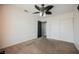 This bedroom has a ceiling fan, neutral carpet and a closet with sliding doors at 664 Mystic Cliffs Ave, Las Vegas, NV 89183
