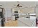 Modern kitchen featuring white cabinets, stainless steel appliances, and a breakfast bar overlooking an adjacent room at 664 Mystic Cliffs Ave, Las Vegas, NV 89183