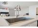Close-up of kitchen island with a modern, stainless steel sink and faucet at 664 Mystic Cliffs Ave, Las Vegas, NV 89183