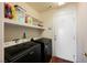 A functional laundry room with newer washer and dryer and ample shelving at 664 Mystic Cliffs Ave, Las Vegas, NV 89183