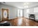 Bright living room with wood floors, decorative fireplace, and a chandelier at 664 Mystic Cliffs Ave, Las Vegas, NV 89183