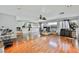 Spacious open-concept living room with fireplace and wood floors, seamlessly connecting to the kitchen area at 664 Mystic Cliffs Ave, Las Vegas, NV 89183