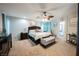 Spacious main bedroom with carpet, ceiling fan, and decorative furniture at 664 Mystic Cliffs Ave, Las Vegas, NV 89183