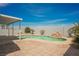Backyard with a sparkling pool featuring a rock waterfall feature and desert landscaping at 664 Mystic Cliffs Ave, Las Vegas, NV 89183