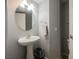 Clean and simple powder room with a pedestal sink and neutral color scheme at 664 Mystic Cliffs Ave, Las Vegas, NV 89183