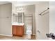 Bathroom featuring tile floors, wood vanity, and a large mirror at 6680 Caporetto Ln # 103, North Las Vegas, NV 89084
