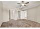 Bedroom with ceiling fan, and multiple doors at 6680 Caporetto Ln # 103, North Las Vegas, NV 89084
