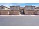 Attractive condo complex showcasing garages, stairwells, and beige stucco exteriors at 6680 Caporetto Ln # 103, North Las Vegas, NV 89084