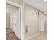 Hallway with neutral walls leading to bedrooms, tiled and carpeted floors, showcasing the layout of the home at 6680 Caporetto Ln # 103, North Las Vegas, NV 89084