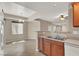 Kitchen featuring wood cabinets, a breakfast bar, tile floors, and an open floor plan at 6680 Caporetto Ln # 103, North Las Vegas, NV 89084