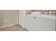 White washer and dryer set in a laundry room with neutral-colored walls and tiled floors, offering convenience and functionality at 6680 Caporetto Ln # 103, North Las Vegas, NV 89084