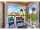 Relaxing covered patio with stylish outdoor furniture and neighborhood views at 6680 Caporetto Ln # 103, North Las Vegas, NV 89084