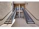 Dual stairwells provide access to the upper-level apartments in this condo complex at 6680 Caporetto Ln # 103, North Las Vegas, NV 89084
