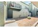 Private backyard with rock landscaping and balcony above, perfect for relaxing outdoors at 7084 Burcot Ave # D27, Las Vegas, NV 89156