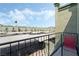 Balcony view of covered parking spaces, palm trees, and building exterior at 7084 Burcot Ave # D27, Las Vegas, NV 89156