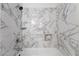 Beautiful bathroom featuring a shower over the tub with marble style tile throughout at 7084 Burcot Ave # D27, Las Vegas, NV 89156