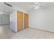 Simple bedroom features tile floors, a ceiling fan, and closet doors at 7084 Burcot Ave # D27, Las Vegas, NV 89156