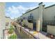 Exterior view of townhomes showing stairways, balconies, and private gated entries at 7084 Burcot Ave # D27, Las Vegas, NV 89156