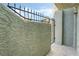 Close up of private courtyard gate and stucco wall leading to front entrance at 7084 Burcot Ave # D27, Las Vegas, NV 89156