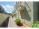 View of building exterior and sidewalk, with balcony above a covered entryway at 7084 Burcot Ave # D27, Las Vegas, NV 89156