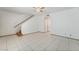 An open living room with staircase and tile flooring at 7084 Burcot Ave # D27, Las Vegas, NV 89156