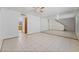 An open-plan living room featuring tile flooring and a mirrored wall at 7084 Burcot Ave # D27, Las Vegas, NV 89156