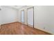 Spacious living room with laminated wood flooring and glass doors at 7084 Burcot Ave # D27, Las Vegas, NV 89156