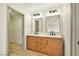 Bathroom featuring a double sink vanity with modern fixtures and a walk-in closet at 744 Willow Ave, Henderson, NV 89002