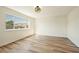 Bright bedroom with light wood floors, large window, and white walls at 744 Willow Ave, Henderson, NV 89002