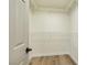 Walk-in closet with white wire shelving and light wood floors at 744 Willow Ave, Henderson, NV 89002