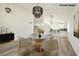 Open dining area featuring a glass table, modern lighting, and access to the kitchen at 744 Willow Ave, Henderson, NV 89002