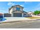 Two-story home with a freshly painted garage, driveway and landscaped front yard at 744 Willow Ave, Henderson, NV 89002