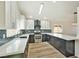 Well-lit kitchen with black bottom cabinets, white top cabinets, and stainless steel appliances at 744 Willow Ave, Henderson, NV 89002