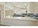 Bright kitchen featuring a breakfast bar, stainless appliances, and stylish backsplash at 744 Willow Ave, Henderson, NV 89002