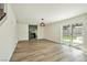 Bright living room with statement fireplace, and sliding glass doors to the backyard at 744 Willow Ave, Henderson, NV 89002